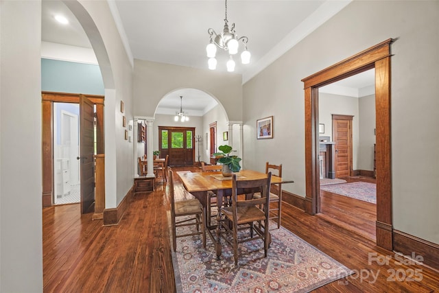 4569 Edgeland Rd, Edgemoor, SC 29712 - dining space featuring arched walkways, dark wood-type flooring, a chandelier, ornamental molding, and baseboards