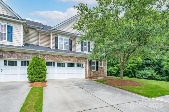 11945 Red Rust Ln, Charlotte, NC 28277 - view of front of property with concrete driveway, an attached garage, stone siding, and a front yard