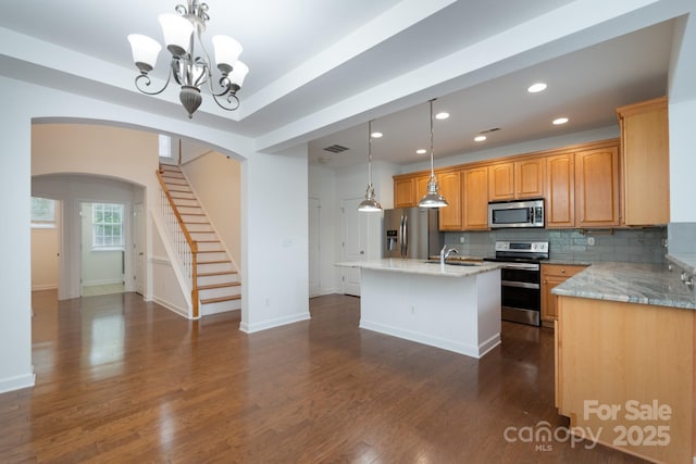 11945 Red Rust Ln, Charlotte, NC 28277 - kitchen with appliances with stainless steel finishes, arched walkways, a chandelier, light stone countertops, and recessed lighting