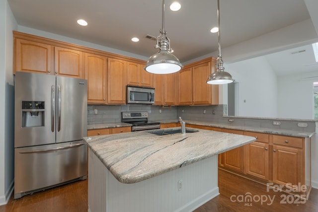 11945 Red Rust Ln, Charlotte, NC 28277 - kitchen featuring stainless steel appliances, tasteful backsplash, dark wood finished floors, a center island with sink, and recessed lighting