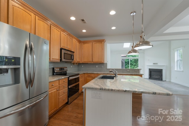 11945 Red Rust Ln, Charlotte, NC 28277 - kitchen with appliances with stainless steel finishes, decorative backsplash, wood finished floors, light stone countertops, and recessed lighting
