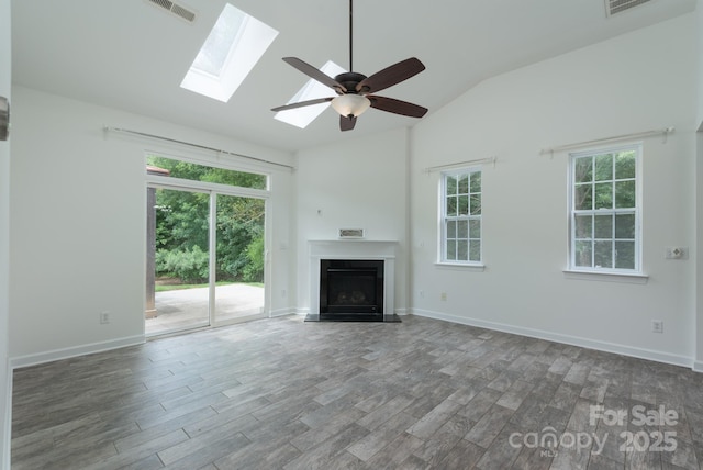11945 Red Rust Ln, Charlotte, NC 28277 - unfurnished living room featuring a fireplace with raised hearth, a skylight, lofted ceiling, wood finished floors, and ceiling fan