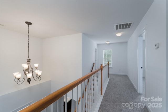 11945 Red Rust Ln, Charlotte, NC 28277 - hallway featuring light colored carpet, a chandelier, and an upstairs landing
