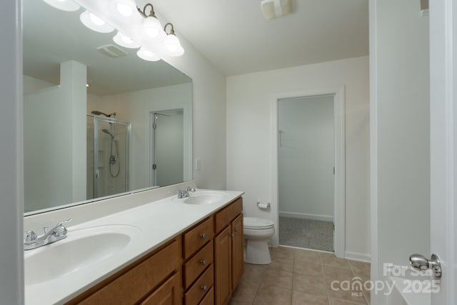 11945 Red Rust Ln, Charlotte, NC 28277 - full bathroom featuring a shower stall, double vanity, tile patterned floors, and a walk in closet