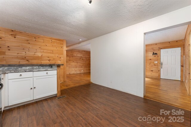 116 Hidden Meadow Dr Unit 17, Candler, NC 28715 - additional living space featuring wooden walls, dark wood finished floors, and a textured ceiling