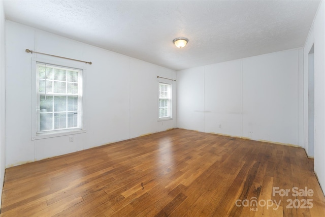 116 Hidden Meadow Dr Unit 17, Candler, NC 28715 - unfurnished room featuring wood-type flooring and a textured ceiling