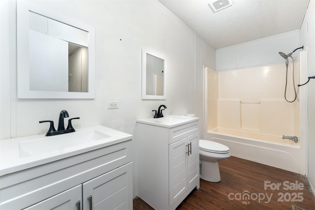 116 Hidden Meadow Dr Unit 17, Candler, NC 28715 - bathroom with two vanities, wood finished floors, toilet, and washtub / shower combination