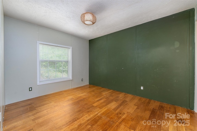 116 Hidden Meadow Dr Unit 17, Candler, NC 28715 - spare room featuring wood finished floors and a textured ceiling