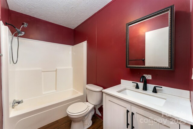 116 Hidden Meadow Dr Unit 17, Candler, NC 28715 - bathroom with a textured ceiling, toilet, wood finished floors, shower / tub combination, and vanity