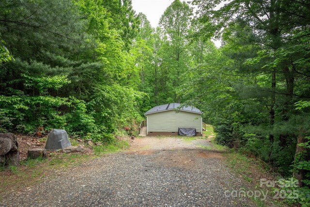 116 Hidden Meadow Dr Unit 17, Candler, NC 28715 - garage with a wooded view and driveway