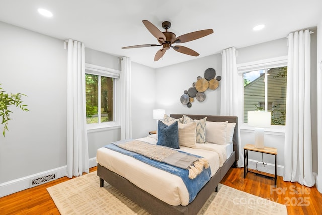 bedroom with wood finished floors, baseboards, ceiling fan, and recessed lighting