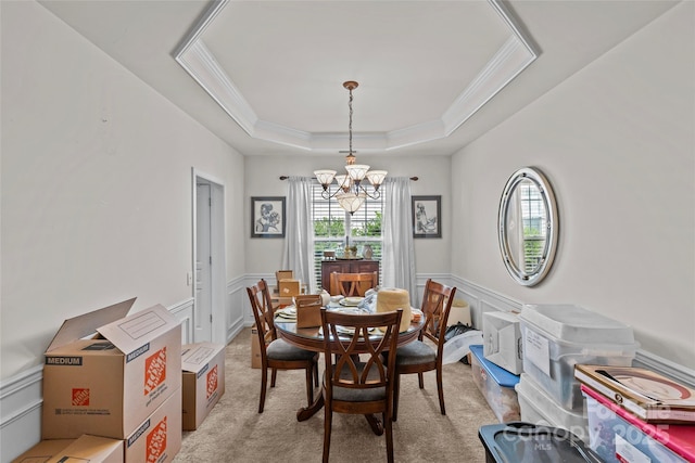 8410 Darcy Hopkins Dr, Charlotte, NC 28277 - dining area featuring a chandelier, light carpet, ornamental molding, a raised ceiling, and a wainscoted wall