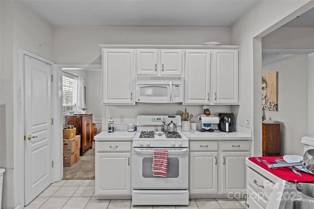 8410 Darcy Hopkins Dr, Charlotte, NC 28277 - kitchen with white appliances, light tile patterned flooring, light countertops, and white cabinets