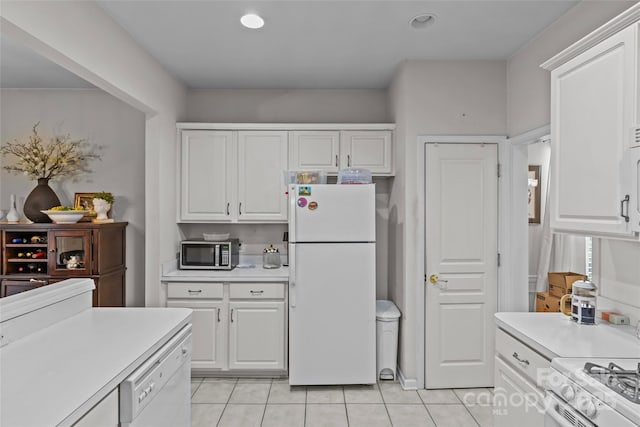 8410 Darcy Hopkins Dr, Charlotte, NC 28277 - kitchen with white appliances, light countertops, light tile patterned floors, white cabinets, and recessed lighting