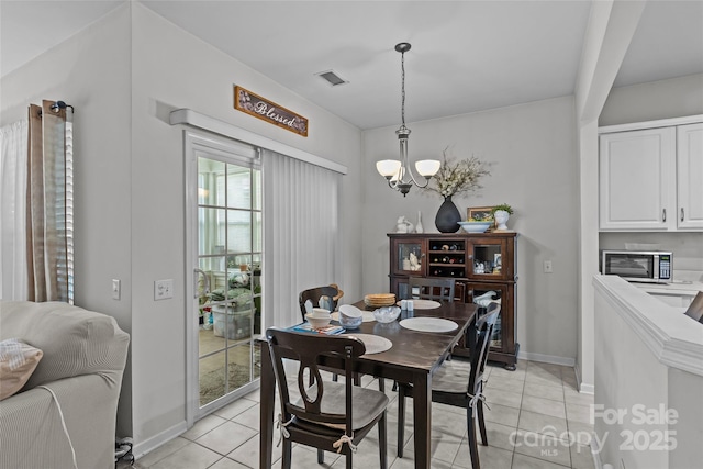 8410 Darcy Hopkins Dr, Charlotte, NC 28277 - dining room featuring light tile patterned floors, a chandelier, and baseboards