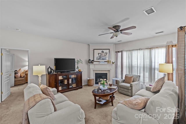 8410 Darcy Hopkins Dr, Charlotte, NC 28277 - living area featuring light colored carpet, a ceiling fan, a glass covered fireplace, and baseboards