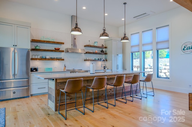 223 Linville View Dr, Nebo, NC 28761 - kitchen featuring stainless steel fridge, open shelves, wall chimney range hood, light wood-style floors, and backsplash
