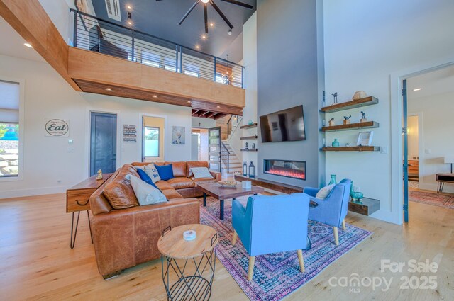223 Linville View Dr, Nebo, NC 28761 - living area with a towering ceiling, wood finished floors, healthy amount of natural light, and a ceiling fan