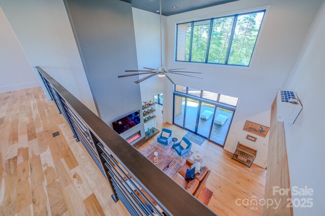 223 Linville View Dr, Nebo, NC 28761 - living room featuring wood finished floors, a ceiling fan, a towering ceiling, and baseboards