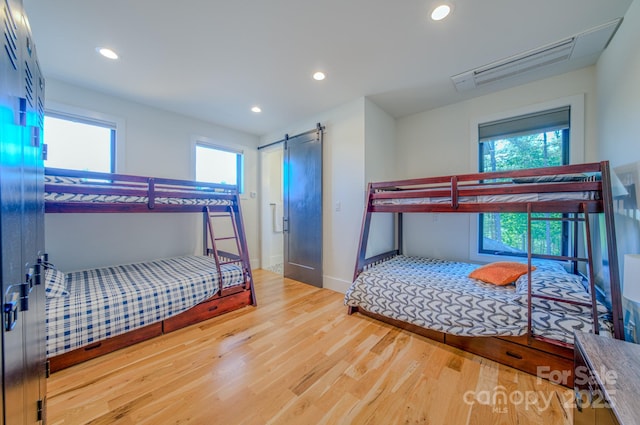 223 Linville View Dr, Nebo, NC 28761 - bedroom featuring wood finished floors, a barn door, recessed lighting, and baseboards