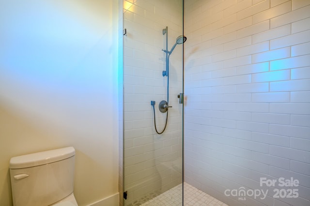 223 Linville View Dr, Nebo, NC 28761 - full bathroom featuring a tile shower, toilet, and baseboards