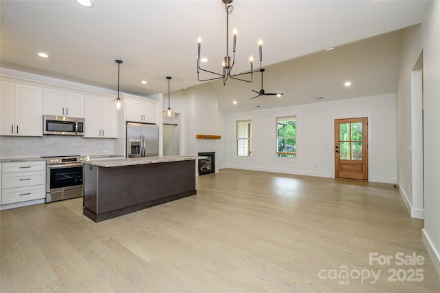 118 W Laurel Ln, Etowah, NC 28729 - kitchen featuring stainless steel appliances, a chandelier, light wood-style floors, a kitchen island, and recessed lighting