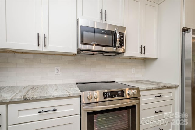 118 W Laurel Ln, Etowah, NC 28729 - kitchen featuring appliances with stainless steel finishes, white cabinetry, and tasteful backsplash