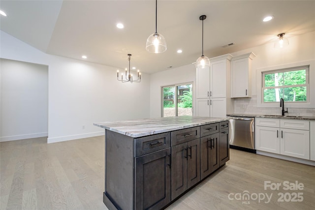 118 W Laurel Ln, Etowah, NC 28729 - kitchen with stainless steel dishwasher, light wood finished floors, white cabinets, plenty of natural light, and recessed lighting