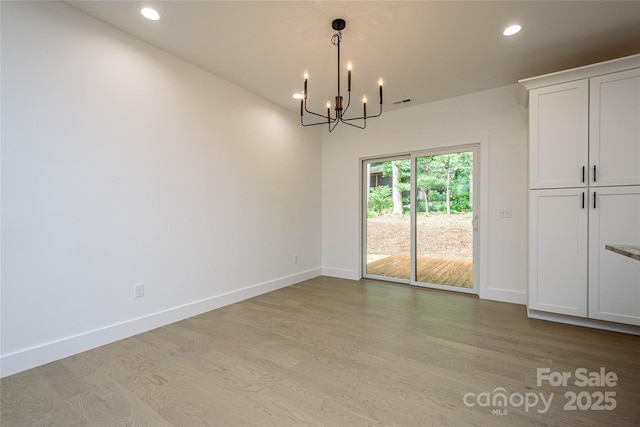 118 W Laurel Ln, Etowah, NC 28729 - unfurnished dining area featuring wood finished floors, a chandelier, and recessed lighting