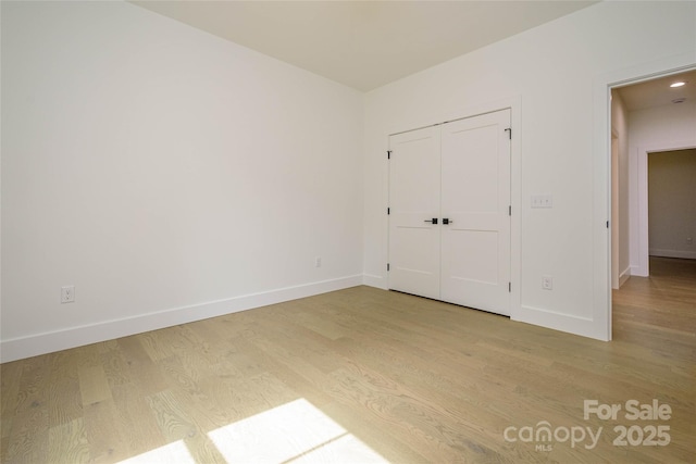 118 W Laurel Ln, Etowah, NC 28729 - unfurnished bedroom with light wood-style flooring and a closet