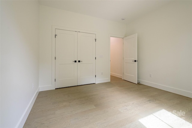 118 W Laurel Ln, Etowah, NC 28729 - unfurnished bedroom featuring light wood-type flooring and a closet