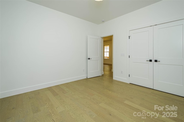 118 W Laurel Ln, Etowah, NC 28729 - unfurnished bedroom with light wood finished floors and a closet