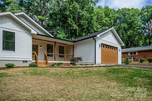 118 W Laurel Ln, Etowah, NC 28729 - modern farmhouse style home with board and batten siding, a porch, a garage, a front lawn, and asphalt driveway