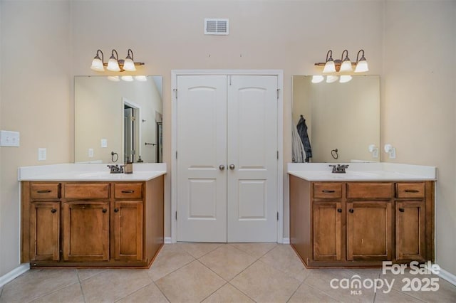 10515 Greenhead View Rd, Charlotte, NC 28262 - bathroom with two vanities, tile patterned floors, and baseboards