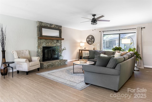 16 Royal Rdg, Clyde, NC 28721 - living room with wood finished floors, a fireplace, ceiling fan, and baseboards
