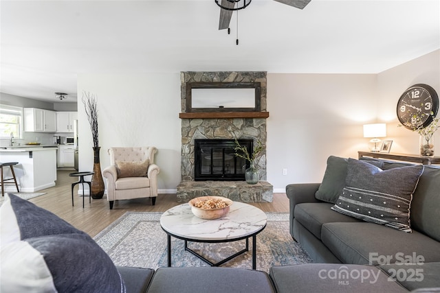 16 Royal Rdg, Clyde, NC 28721 - living room with ceiling fan, light wood-type flooring, a fireplace, and baseboards