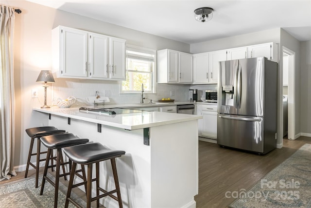 16 Royal Rdg, Clyde, NC 28721 - kitchen with appliances with stainless steel finishes, a peninsula, a sink, and white cabinetry