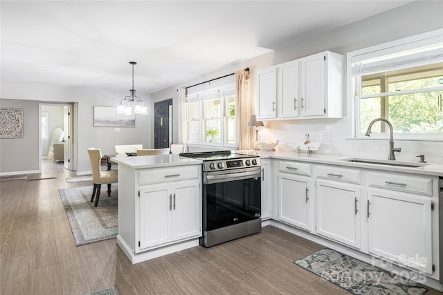 16 Royal Rdg, Clyde, NC 28721 - kitchen with stainless steel range with electric stovetop, a sink, dark wood-style floors, and a peninsula
