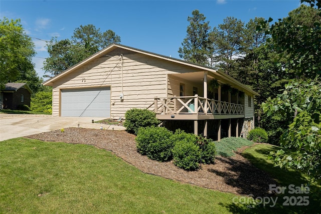 16 Royal Rdg, Clyde, NC 28721 - view of property exterior with concrete driveway, a balcony, an attached garage, and a lawn