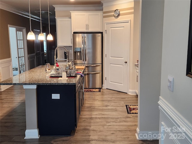 813 Latrobe Dr Unit 365, Iron Station, NC 28080 - kitchen with stainless steel fridge with ice dispenser, crown molding, dark stone countertops, white cabinets, and an island with sink
