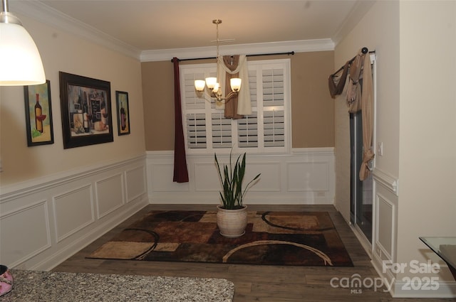 813 Latrobe Dr Unit 365, Iron Station, NC 28080 - dining area featuring a chandelier, dark wood-style floors, crown molding, wainscoting, and a decorative wall