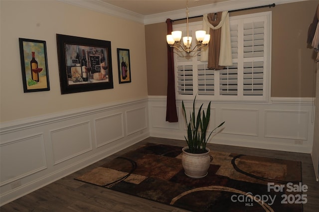 813 Latrobe Dr Unit 365, Iron Station, NC 28080 - dining room featuring a chandelier, dark wood-style floors, a wainscoted wall, a decorative wall, and ornamental molding