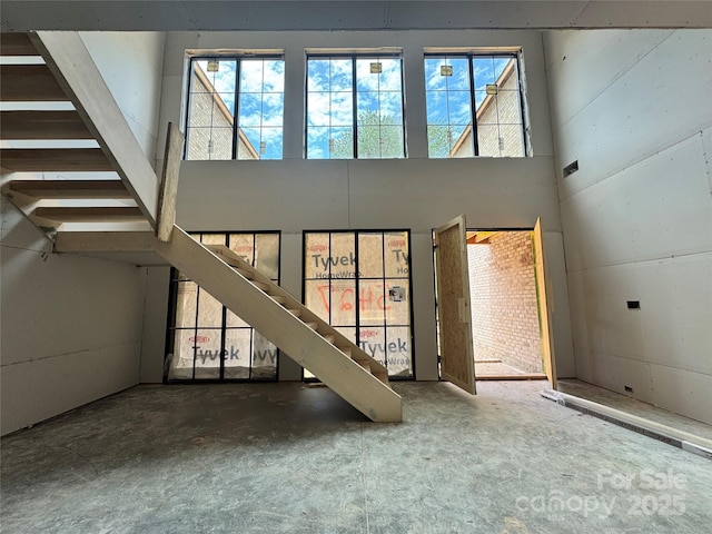 5427 Addison Dr, Charlotte, NC 28211 - unfurnished living room with stairs and a high ceiling