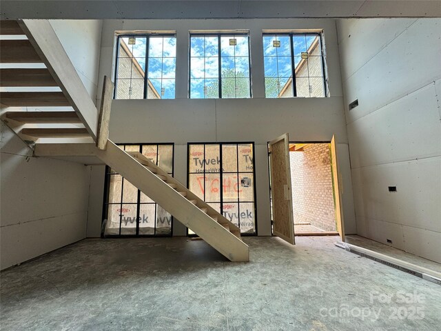 5427 Addison Dr, Charlotte, NC 28211 - unfurnished living room with stairs and a high ceiling
