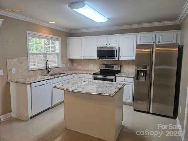 kitchen with appliances with stainless steel finishes, a sink, ornamental molding, white cabinets, and backsplash