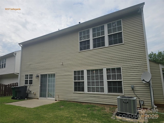 rear view of house featuring cooling unit