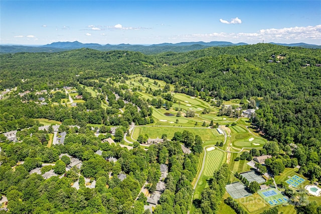 200 Maple Hill Dr, Flat Rock, NC 28731 - drone / aerial view of a heavily wooded area, a mountainous background, and a local golf course