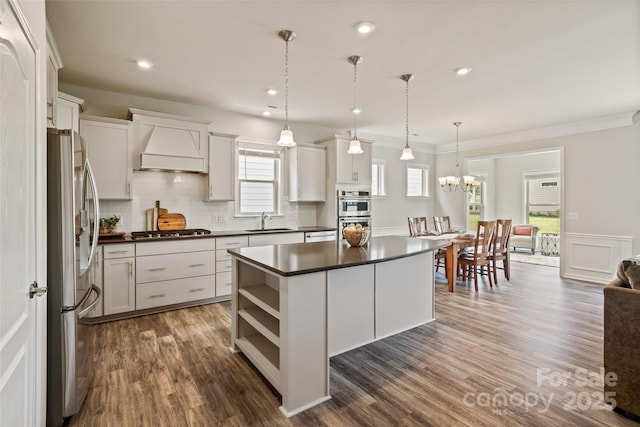 2329 Delaney Dr, Fort Mill, SC 29715 - kitchen with appliances with stainless steel finishes, dark countertops, custom exhaust hood, a kitchen island, and a sink