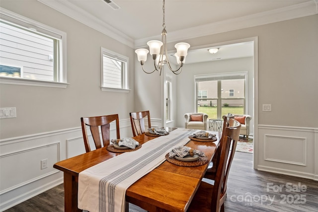 2329 Delaney Dr, Fort Mill, SC 29715 - dining room featuring a chandelier, dark wood-style flooring, a wainscoted wall, ornamental molding, and a decorative wall