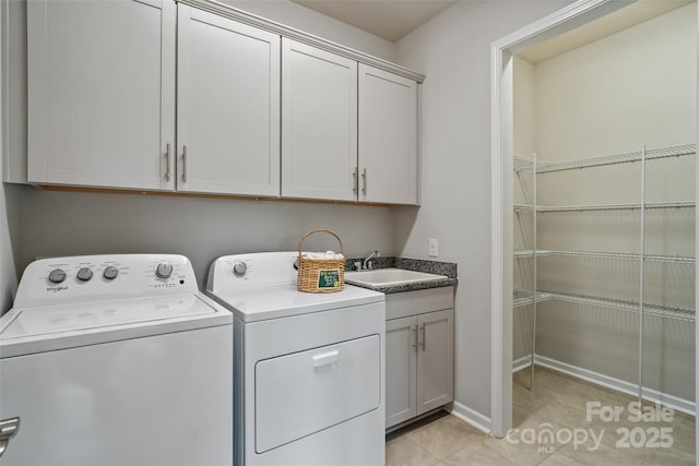 2329 Delaney Dr, Fort Mill, SC 29715 - washroom with washing machine and dryer, cabinet space, light tile patterned floors, and baseboards
